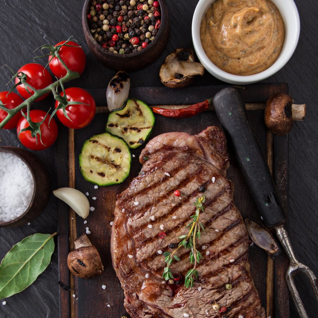 Delicious beef steak on black stone table, close-up.
